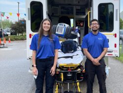 NCCC EMT students pose by an ambulance during their hands-on learning classes.