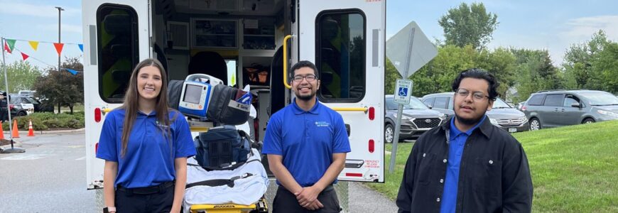 NCCC EMT students pose by an ambulance during their hands-on learning classes.