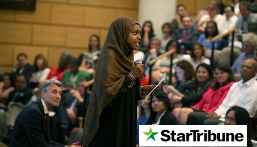 A woman lectures a group of people.